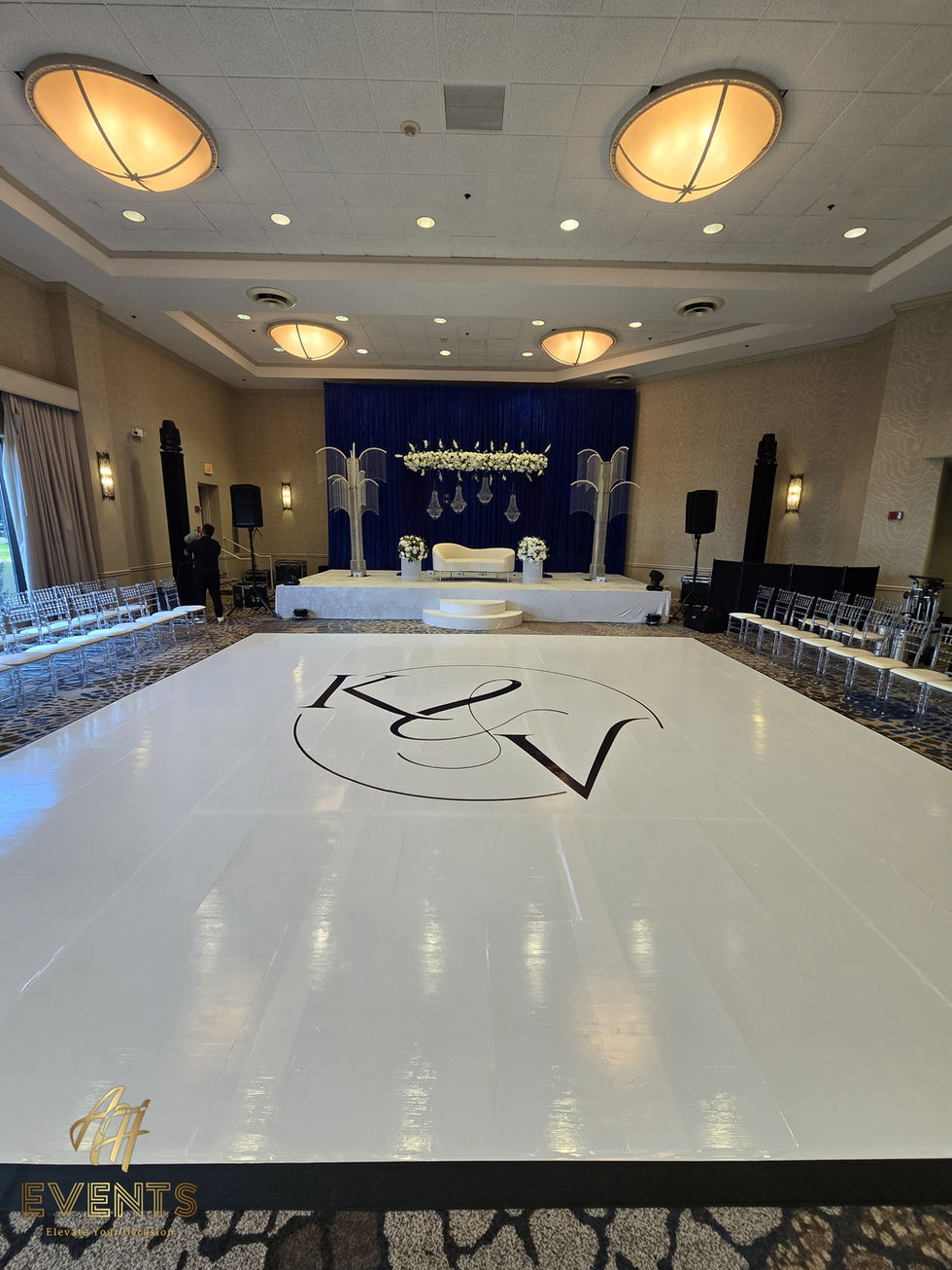 Personalized white vinyl dance floor with a custom gold monogram by AH Events for luxury wedding branding.