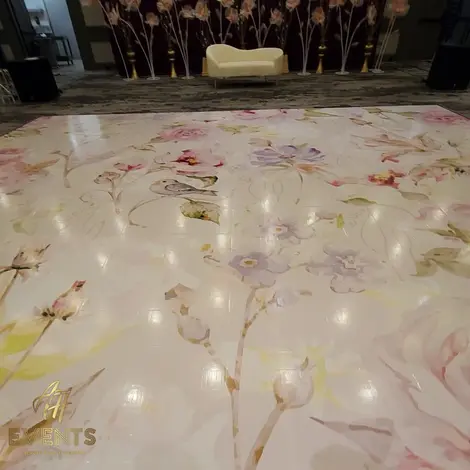 a white dance floor with flowers painted on it