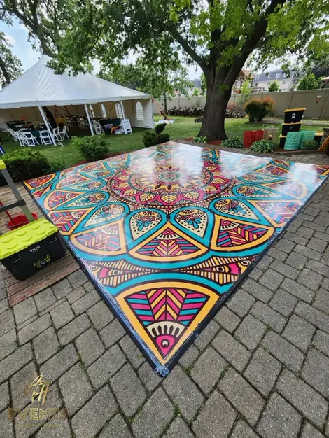 a colorful dance floor in front of a white tent