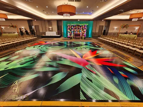 a large room with a dance floor with a colorful design on it
