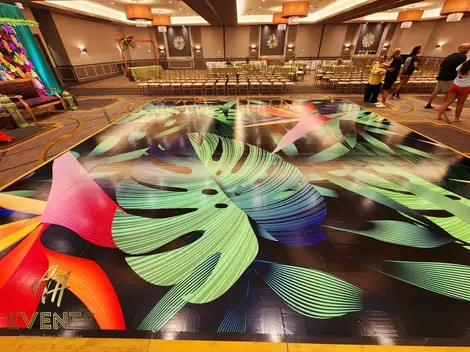 a dance floor with tropical leaves painted on it