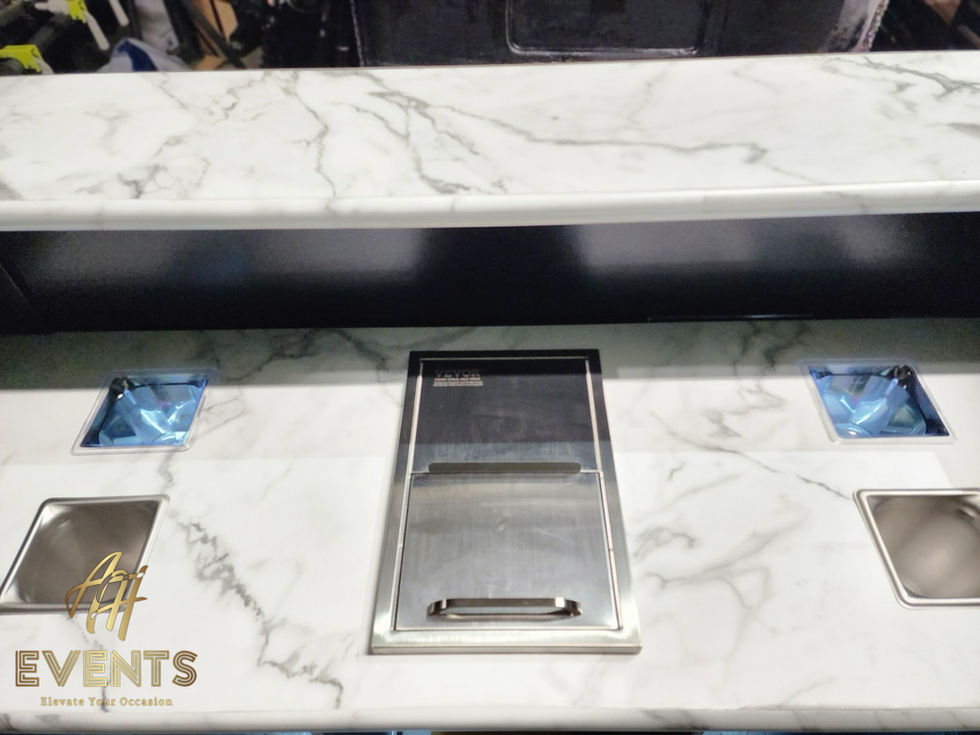 a marble counter top with a stainless steel pans