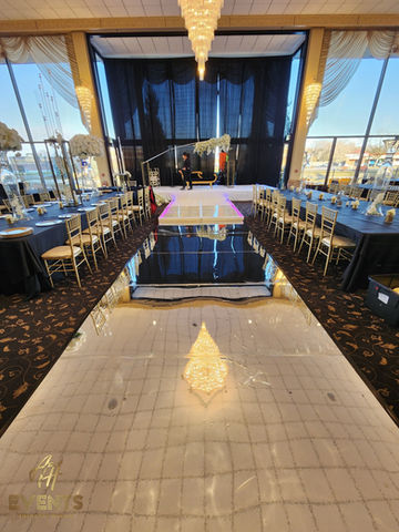 luxury event floor featuring a high-gloss mirror vinyl and structural glass walkway combination