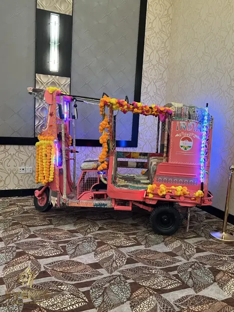 a pink rickshaw with the word india on the side