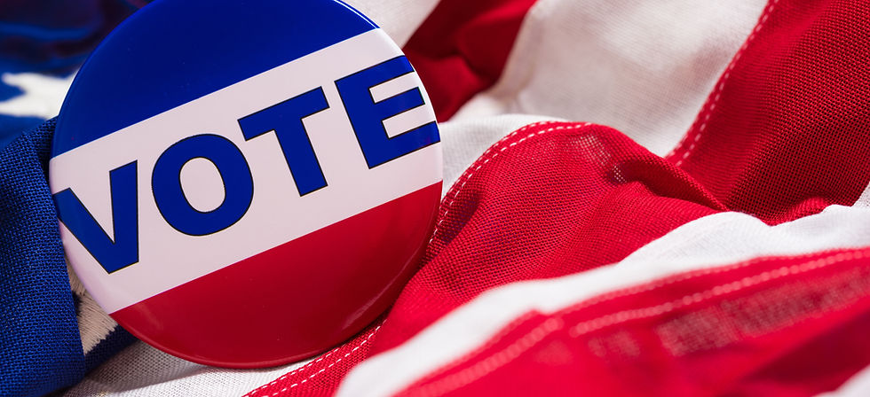 red white and blue vote pin on a flag