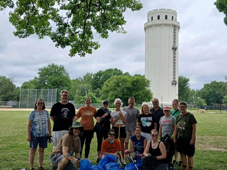 Waldo Tower with volunteers standing in front holding tools and trash bags