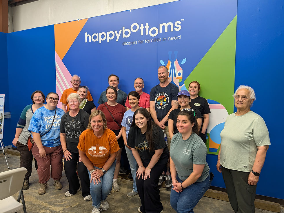 Waldo volunteers standing in front of a HappyBottoms logo