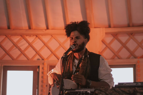 Live musical performance during immersive evening experience at Heartland Gathering
