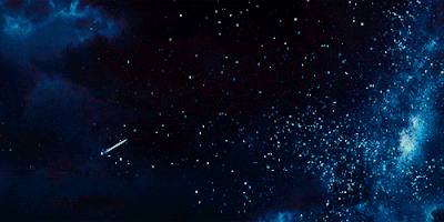 a gif of a shooting star with the entire starry cosmos at its back