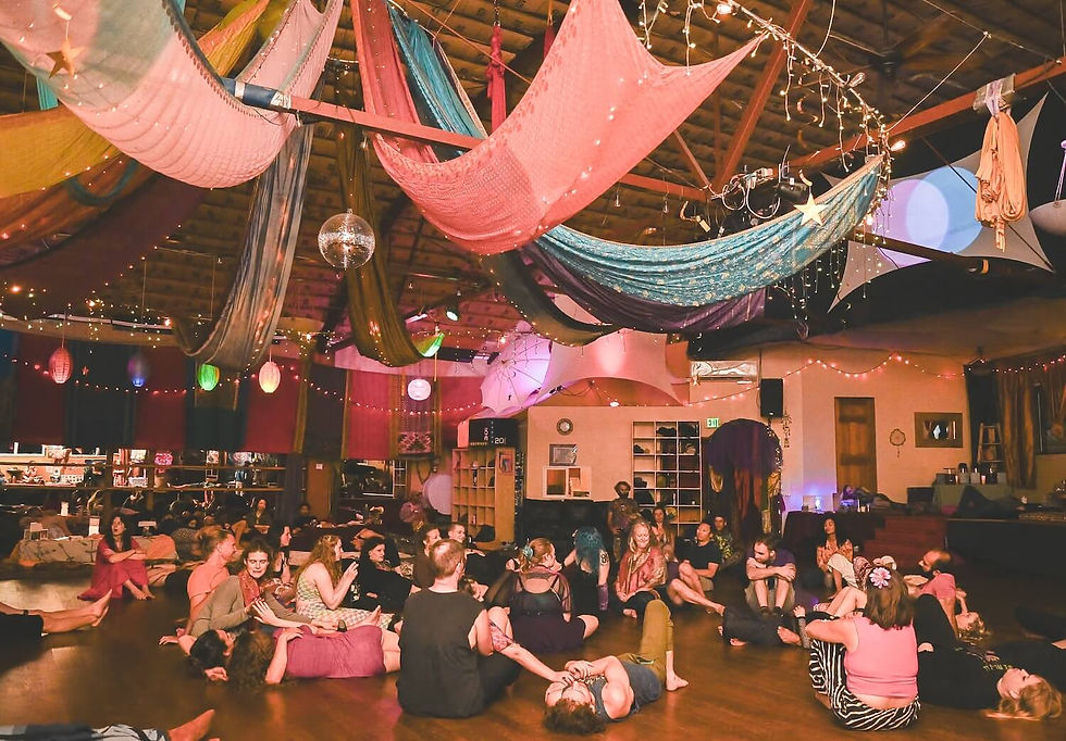 Participants gathered in a closing circle during an ecstatic dance event at Seattle Ecstatica