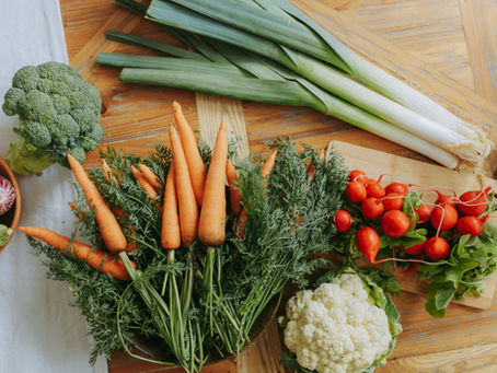 raw veggies ready to be prepped laying on a cutting board