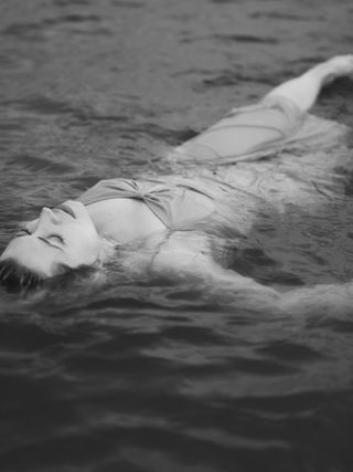 a woman floating in water at Alum Creek State Park Beach