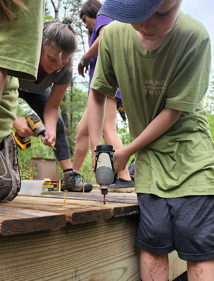 children helping to build trail catwalks