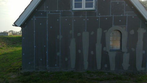 Hus med påbegyndt facaderenovation