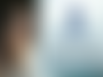 woman looking out window contemplating