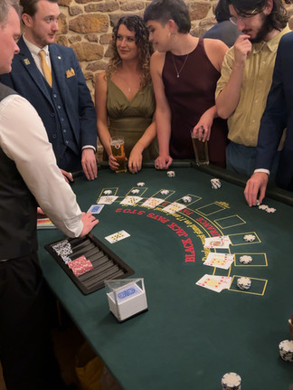 The casino table, black jack host dealing cards to wedding guests
