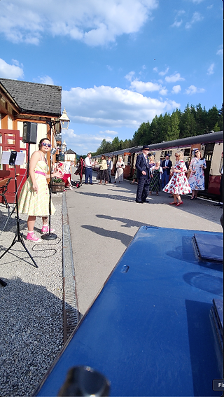 Dancing in the sunshine infront of the train