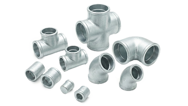Assorted galvanized iron socket weld fittings including tees and elbows with a light grey zinc-coated finish.