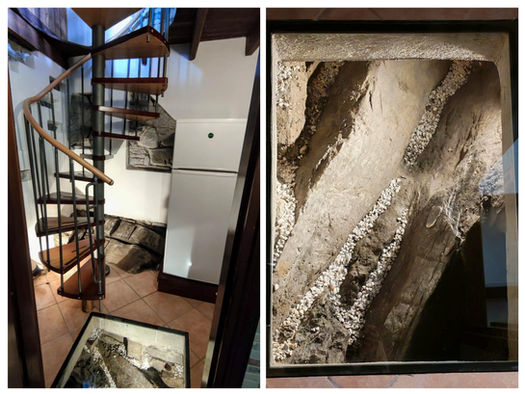 Dettaglio architettonico unico: roccia a vista e scala a chiocciola Trekking House Como Lake