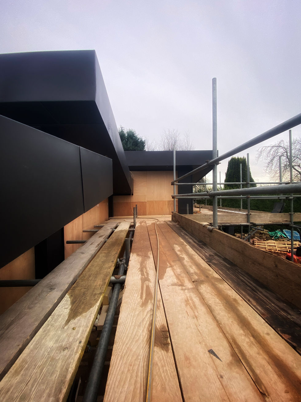 a wooden walkway with scaffolding on the side of it