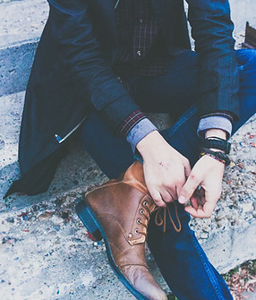 Man in Sports Jacket Tying His Shoes