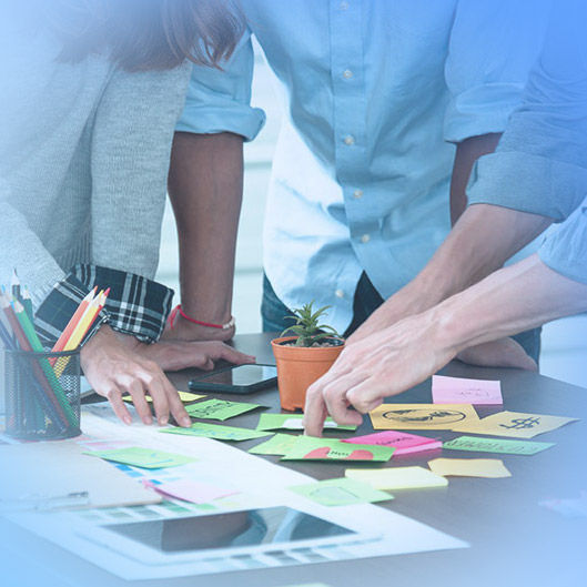 Business people studying sticky notes.