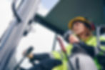 Female worker operating heavy machinery