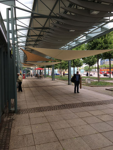 Moderne Markthalle mit Sonnenschutz und Passanten