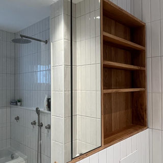 white bathroom built in wood cabinet and mirror