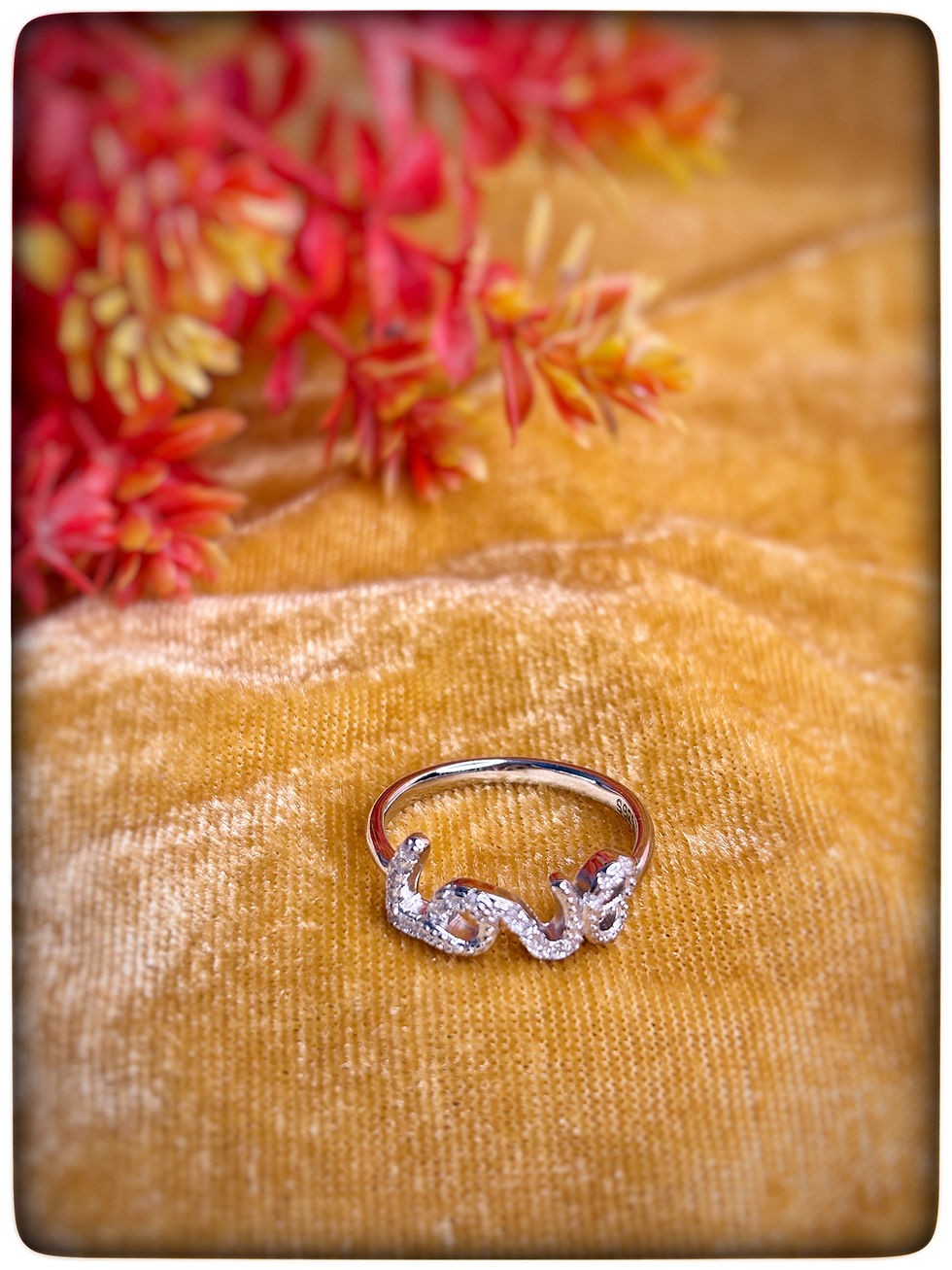 925 Sterling Silver Love Ring with Sparkling Stones on Velvet Background