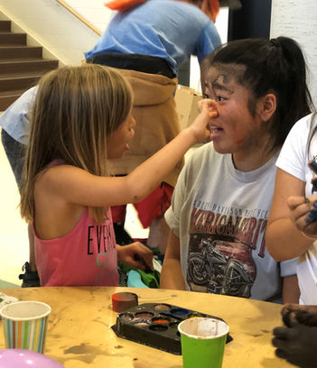 Child paints face of HVC participant