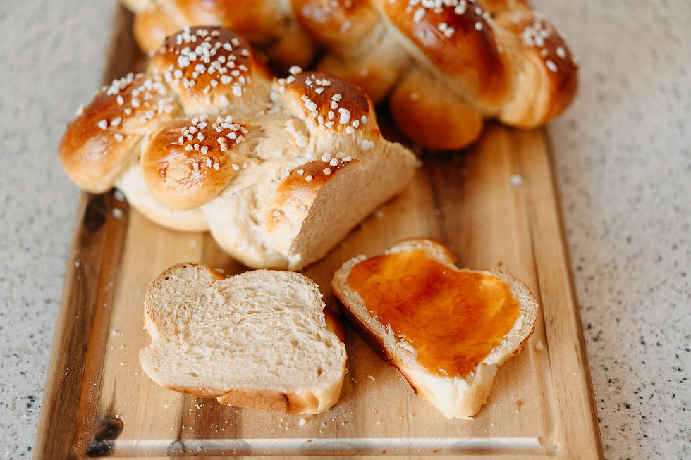 Germteigzopf in Scheiben geschnitten mit Butter und Marillenmarmelade