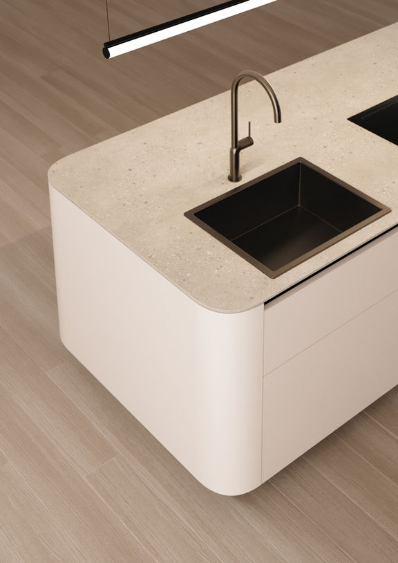 Space-saving curved kitchen with a central island

