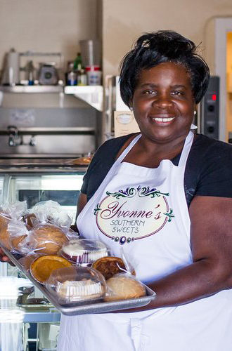 Yvonne at her bayview store. showing some of her famous baked goods.