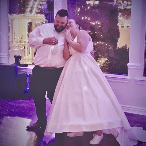 A bride and groom swaying gracefully on the dance floor.