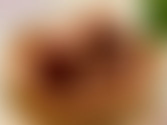 Gula melaka (palm sugar) on a woven mat. Bright setting, green leaf in the background, earthy tones.