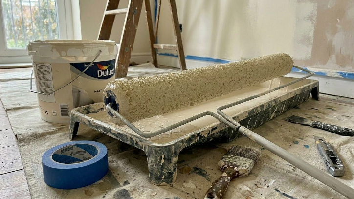 Close-up of an 18-inch paint roller with fresh wall paint