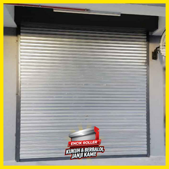 Worker using manual chain override on automatic roller shutter door