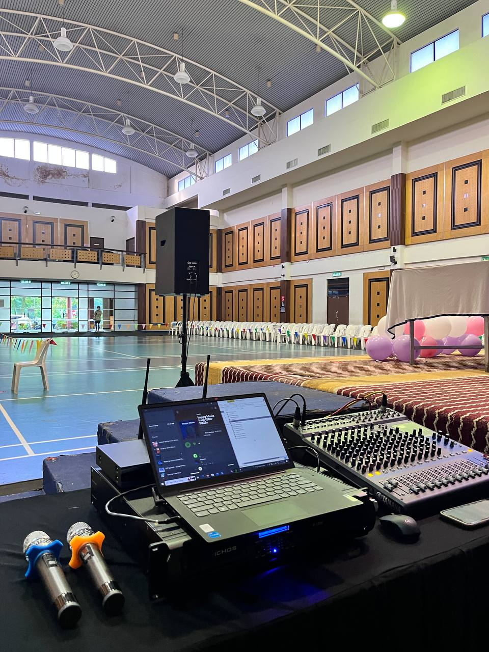 Sound technician setting up mixer PA system in Selangor ballroom