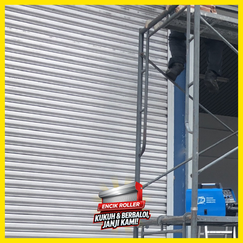 Industrial warehouse with large automatic roller shutter door and workers operating safely
