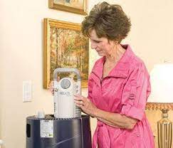 Woman adjusting a home liquid oxygen system for medical use