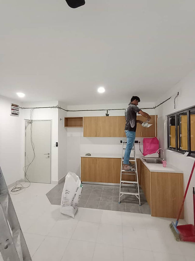 Electrician installing concealed wiring pipes behind wall