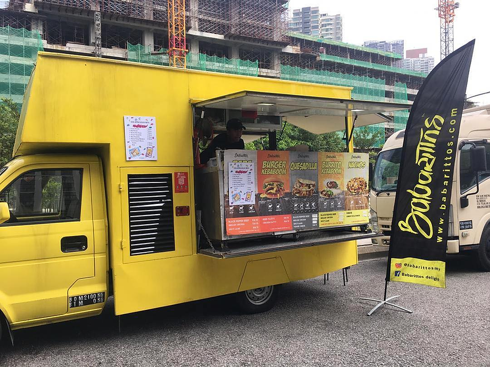 Food truck parked in residential area with student traffic