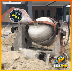 Homeowner using small cement mixer for DIY outdoor renovation