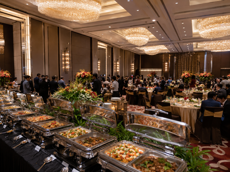 Catering service in a community hall with buffet and dining table setup.