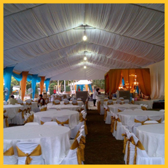 Malay bride and groom posing under a transparent marquee tent
