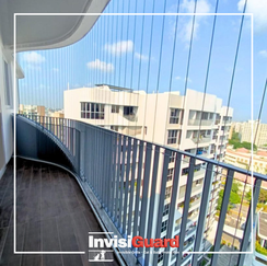 Woman enjoying morning coffee on high-rise balcony with invisible grille protection