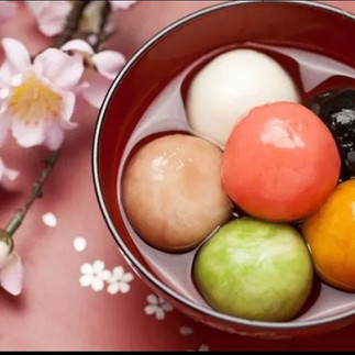 Table full of traditional Chinese New Year food in Malaysia – mandarin oranges, kuih kapit, and pineapple tarts
