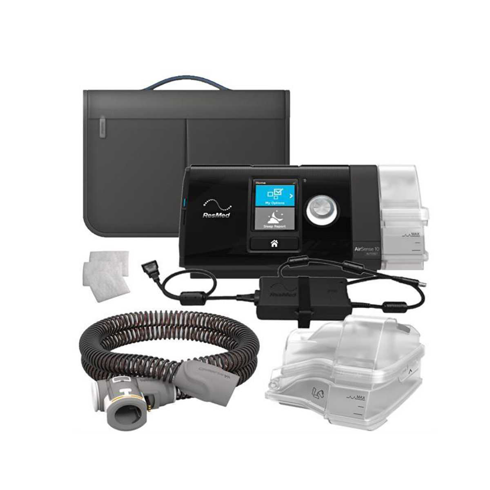 CPAP machine set with a black main device, flexible hose, filters, and gray accessories, placed against a white background.