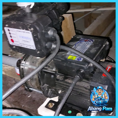 Technician checking electrical connection of residential water pump